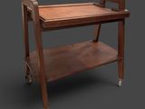 an image of a wooden serving cart with wheels on a gray background