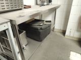 a kitchen with a stove, oven, and other items on the counter