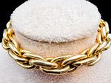a close up of a gold chain necklace on a mannequin mannequin