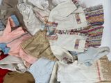 a lot of clothes that are sitting on a bed