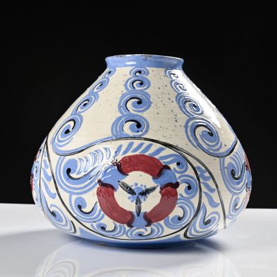 a blue and white vase sitting on a white table