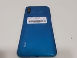 a close up of the back of a blue phone with a barcode on it