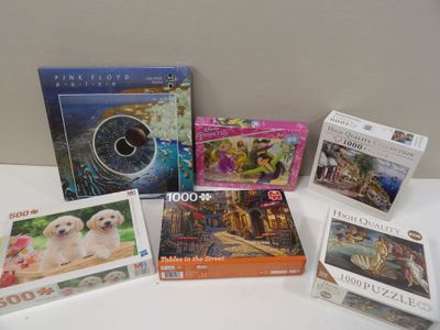 many puzzles and games on the table together
