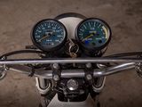 two gauges on the handlebars of a motorcycle