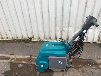 a blue machine that is sitting on the side of the street