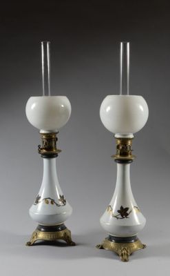 pair of white and gold candlesticks with glass shades