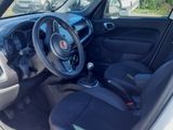 the interior of a small car with black seats and a steering wheel