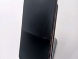 an image of a cell phone sitting on top of a metal stand