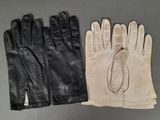 pair of black and white leather gloves on a gray surface