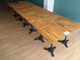 a long wooden table with four legs on it