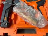 an orange tool box with tools in it sitting on a table
