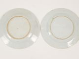 pair of white plates with brown rims on a white surface