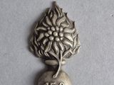 an image of a silver bell with a flower on it