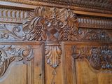a wooden armoire with a bunch of carvings on it