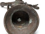 a metal object that is sitting on a white surface