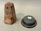 two pieces of pottery that are sitting on a table