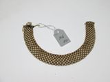 a close up of a gold bracelet with a tag on it