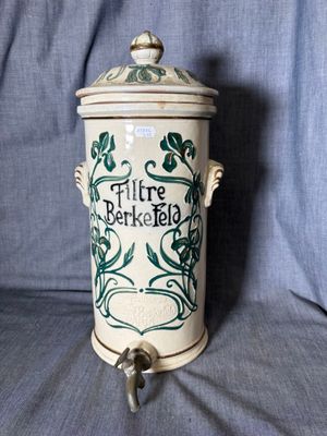 a ceramic container with a lid and a handle