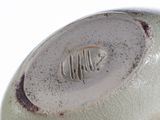 a close up of a vase with a fish on it