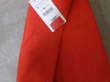 an image of a pair of red pants sitting on top of a couch