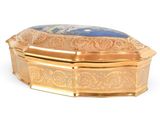 a gold box with a blue stone inside of it