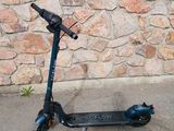 an electric scooter parked in front of a stone wall