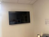 une télévision à écran plat fixée au mur dans un coin de la pièce