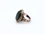 an image of a ring with a black stone