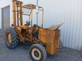 a tractor that is parked in front of a building
