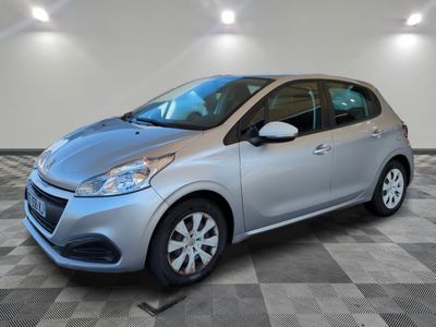 a silver car parked in a garage with a checkered floor