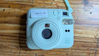 a small camera sitting on a table with a tag on it