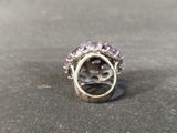 an image of a ring with amethorate and diamonds on a table
