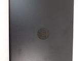 the back of a laptop with a black cover on a white surface