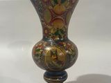 a vase that is sitting on a white surface