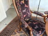 a chair that is sitting on a rug in a room