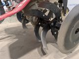 a close up of a tractor with a plow attached to it