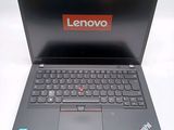 a black laptop with a red lenovo logo on the screen