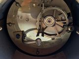 a close up of a clock inside of a metal container