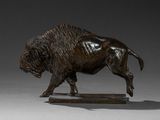bronze statue of a bison on a wooden base