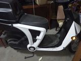 a scooter that is parked in a garage