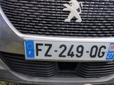 a close up of the front of a car with the number plate on it