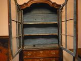 an old wooden cabinet with open doors in a room