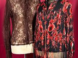 two women ' s jackets on a mannequin stand against a red background