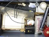 a blue box filled with assorted items and a clock
