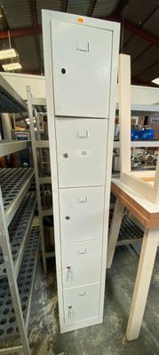 a tall white filing cabinet in the middle of a room