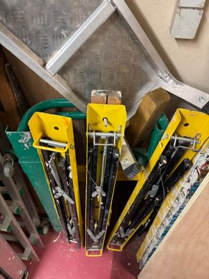 many skis and ski poles stacked on top of each other