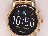 a gold smart watch with a black face on display