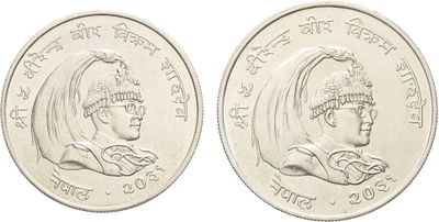 a close up of two indian coins on a white background