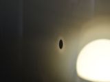 a light that is shining on a toilet in the bathroom