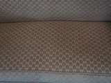 an image of a couch that has a pillow on top of it